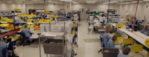 workers working at work stations on a manufacturing floor