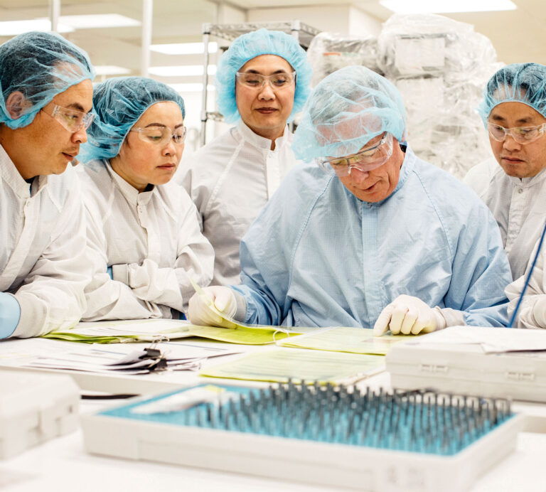 Viant employees gathered around a table looking at some notes