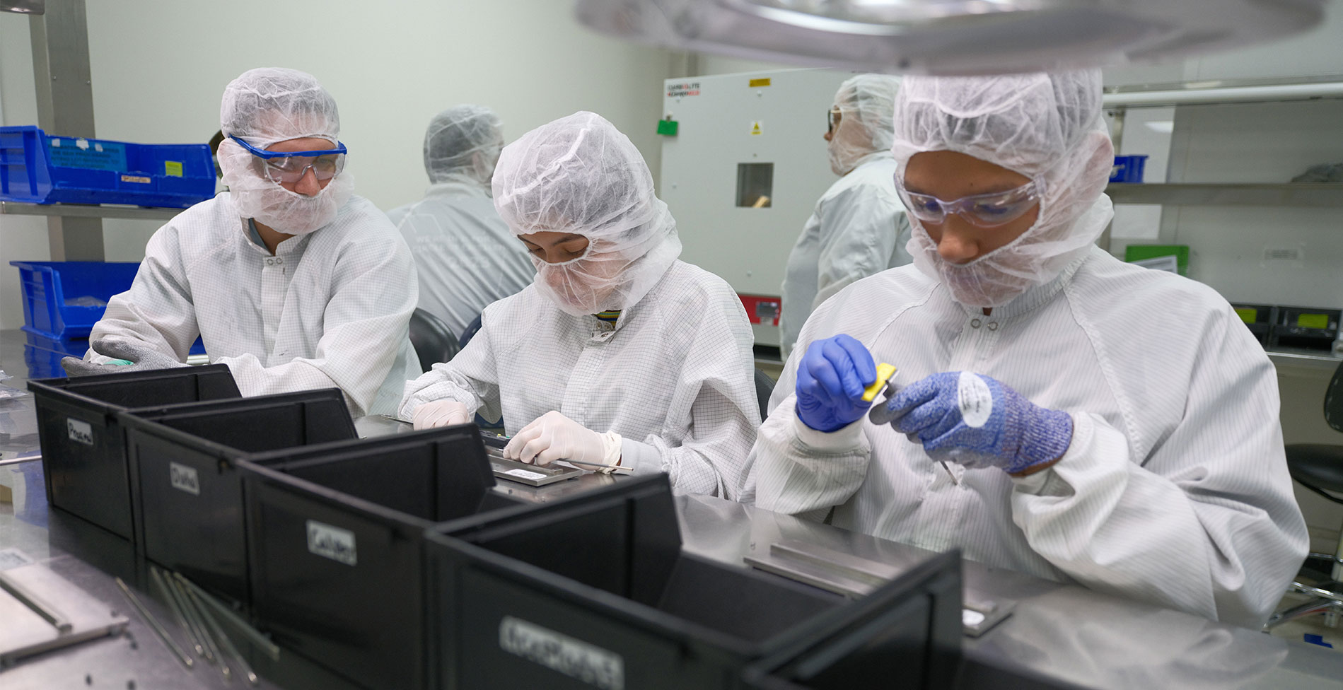 Employees standing in the lab working together.