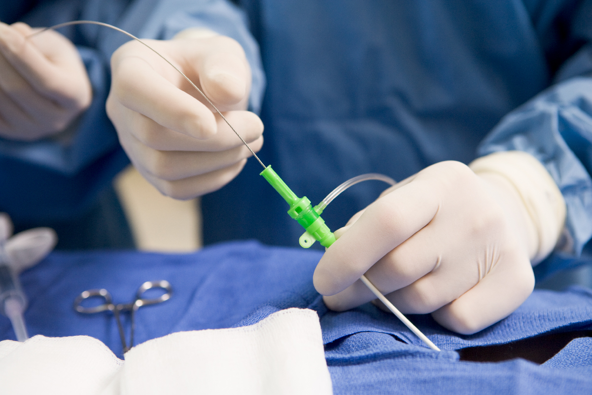 A surgeon skillfully holds a needle and syringe, preparing for a medical procedure in a sterile environment.