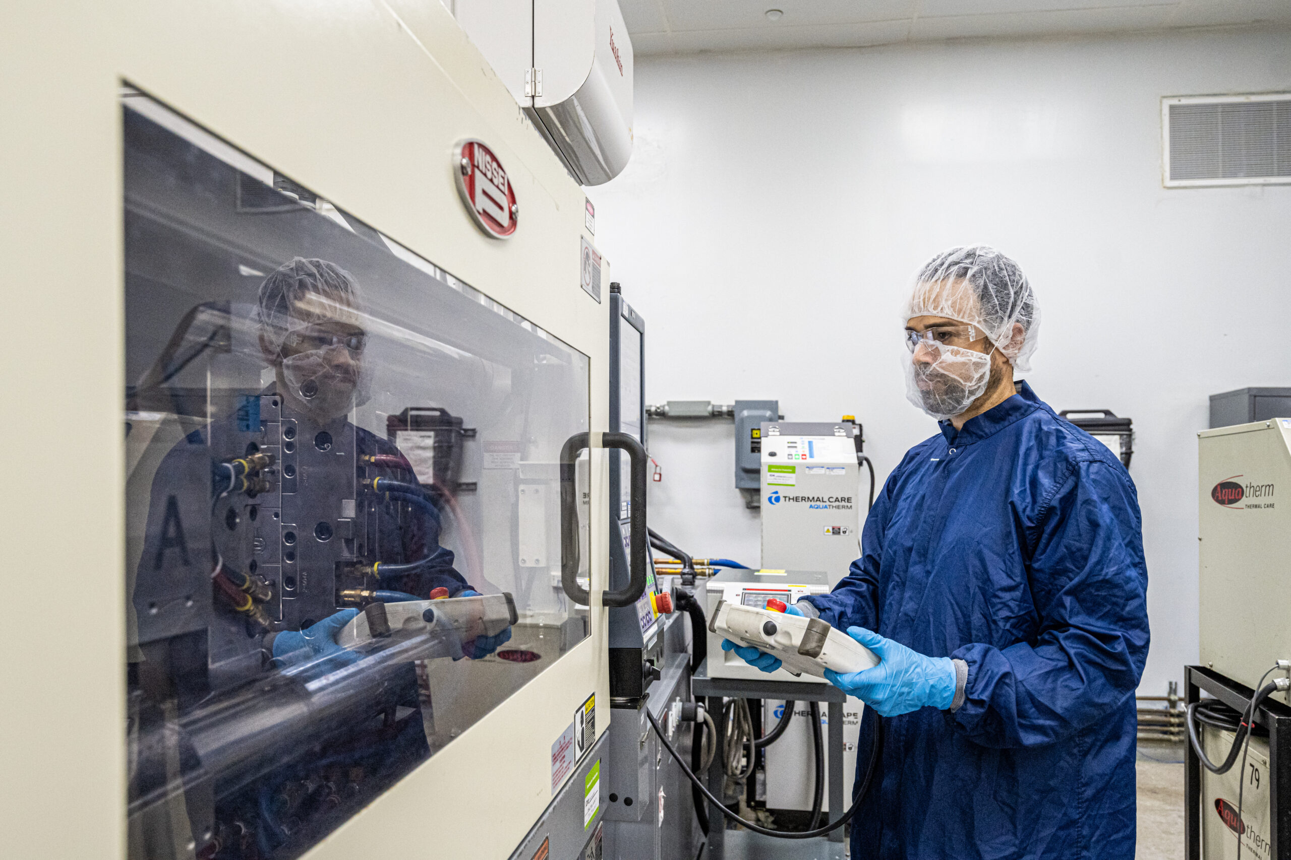 an employee using a machine in a lab