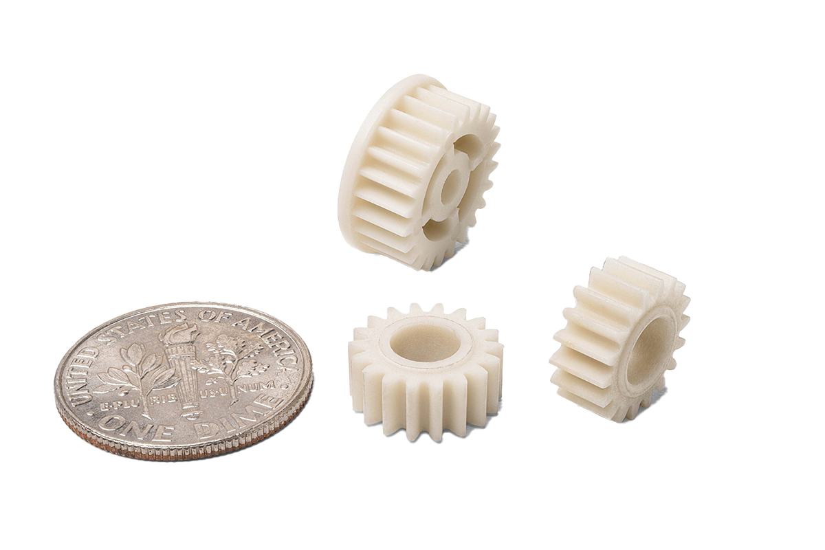 Micro-Mechanical componentsa sitting next to a dime to demonstrate size.