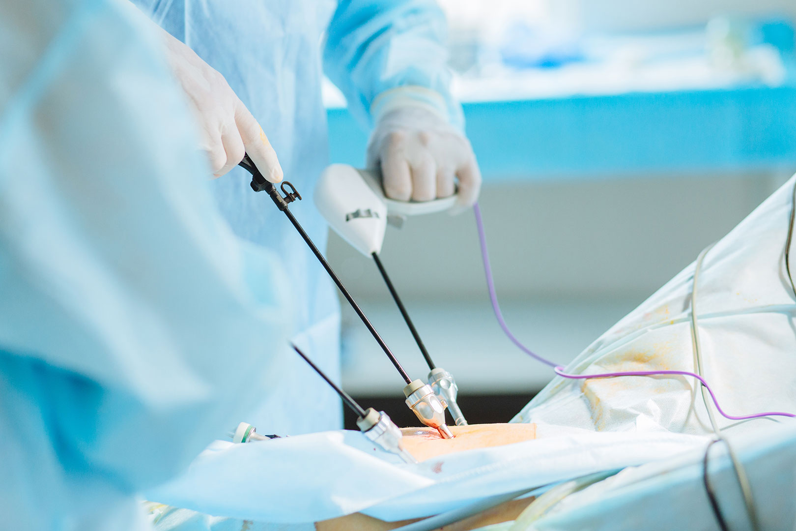 a medical professional completing a procedure with surgical device technologies