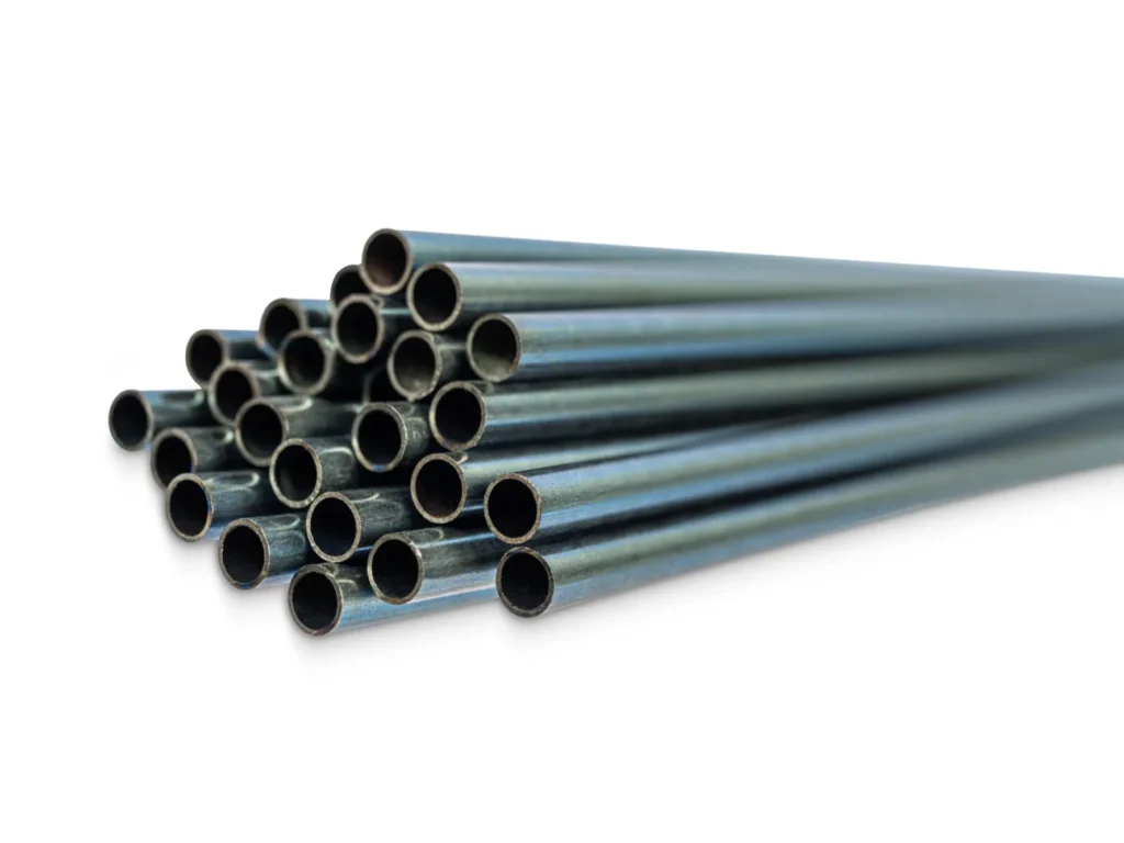 A bundle of metal medical tubes or hypotubes stacked together.