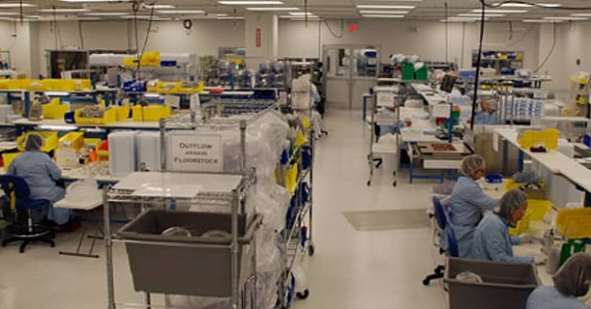 workers working at work stations on a manufacturing floor