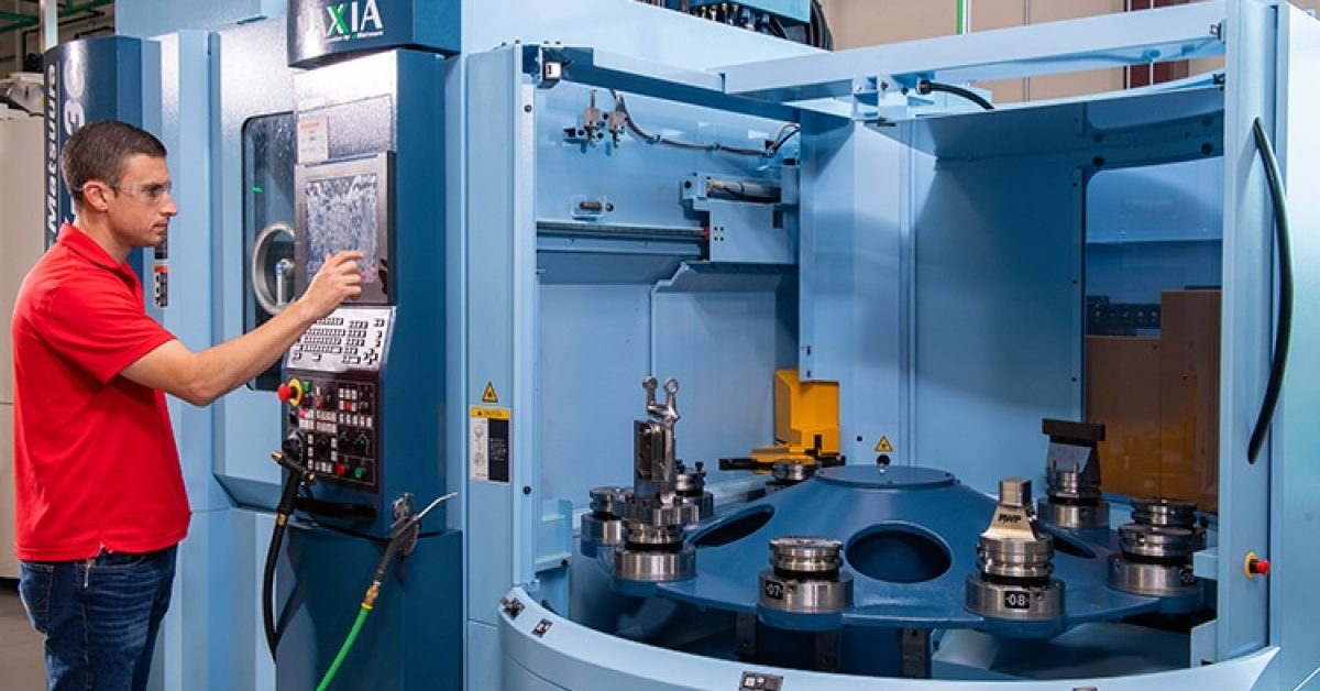 A viant employee working with a machine for metal processing